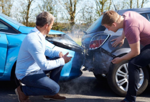 Uma batida traseira e seus respectivos motoristas a frente, vendo o resultado do acidente.
